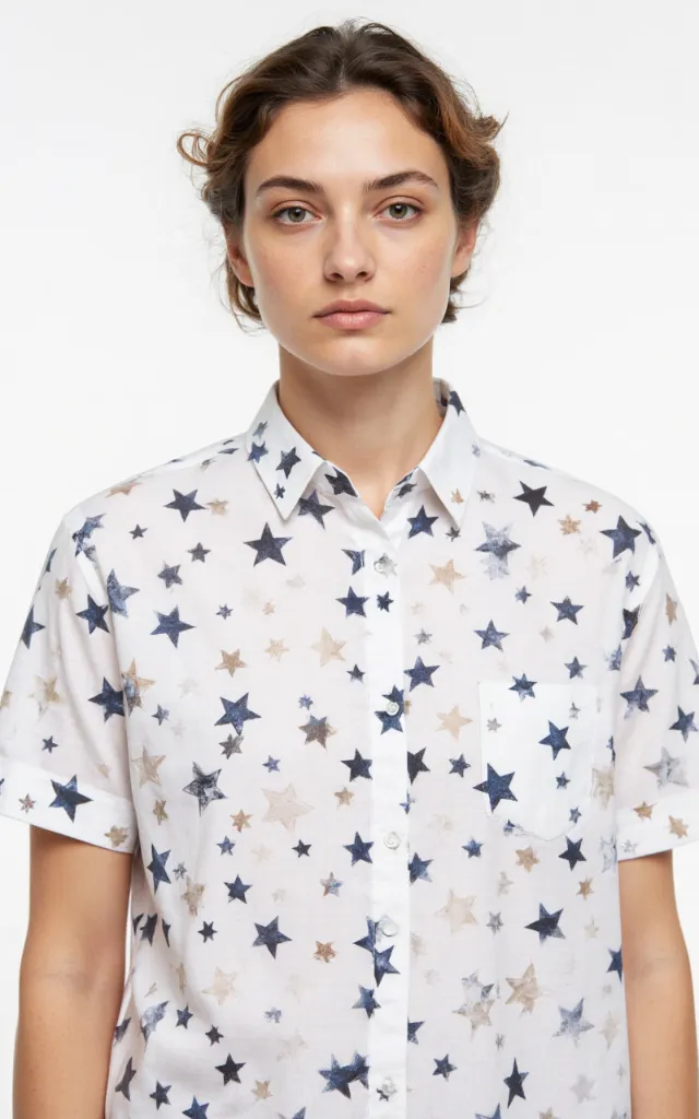 A French model wearing a Star   shaped pattern   printed shirt, against a white background, in a front   facing bust portrait